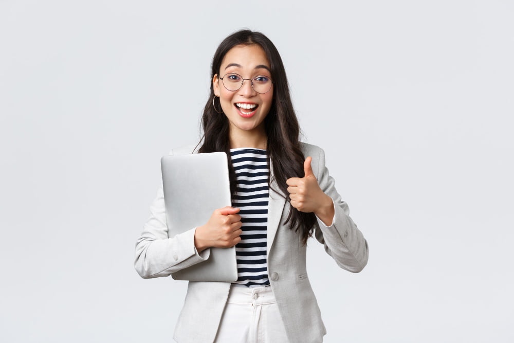 business finance employment female successful entrepreneurs concept young confident businesswoman glasses showing thumbs up gesture hold laptop guarantee best service quality
